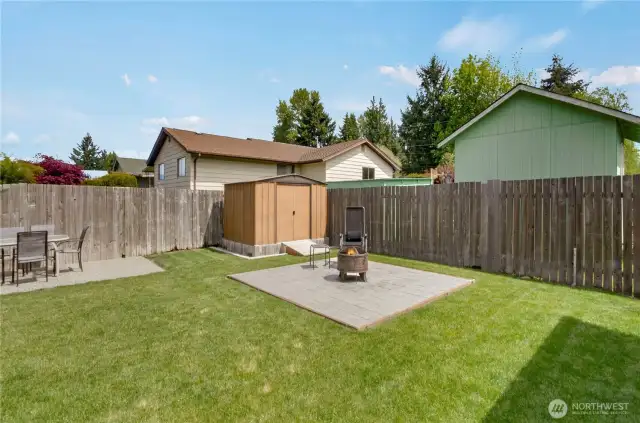 The third of three patio seating areas is perfect for a firepit! Here you also see the ramp accessing the garden outbuilding, which makes mower access easy.
