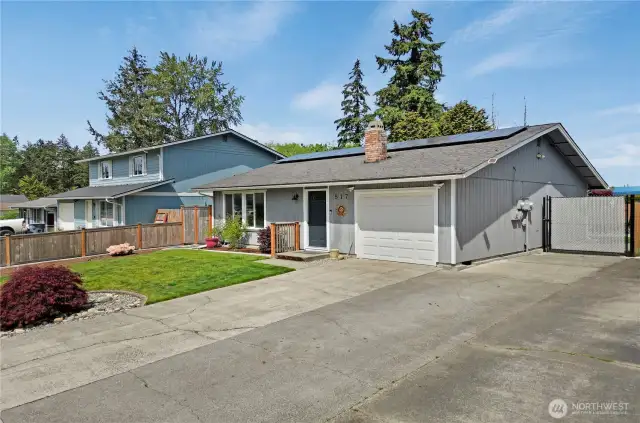 The neighborhood is quiet and well maintained, and just around the corner from Tacoma's celebrated Charlotte's Blueberry Park! At the right side you can see the secure gate allowing wheeled access into the fenced backyard.