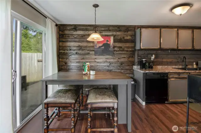 The dining room is perfectly situated between the kitchen and the living room and offers access to the side yard with one of the three patio seating areas. The kitchen features a very modern crisp look with gorgeous wood tone accents you'll love!