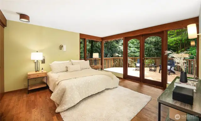 The primary suite on the main level with French doors to its own deck.
