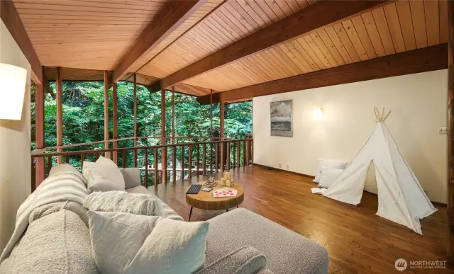The loft on the upper level overlooks the living room below.
