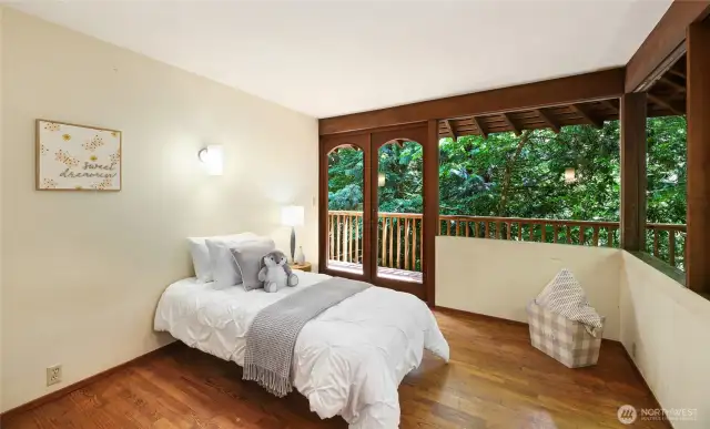 Bedroom 4 on the upper level with access to balcony.