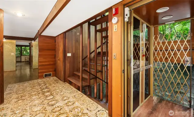 The entry features hand-made agate stone pavers. The elevator serves all three levels.