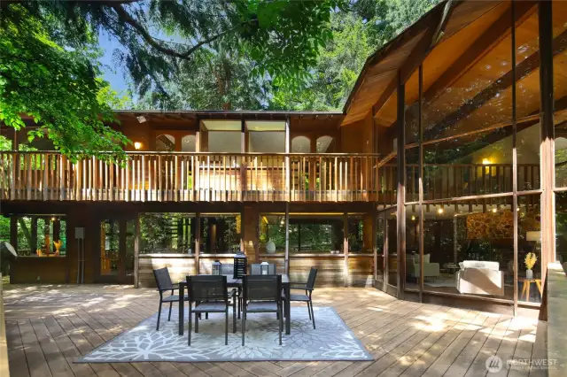 Looking across the deck with the kitchen/family room on the main level and the bedroom wing upstairs.