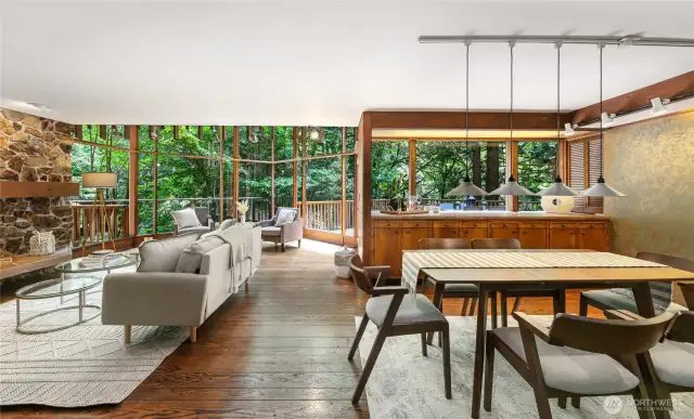 The open plan dining and living areas with breathtaking view onto the wooded surroundings.