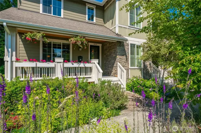 Well-lit front entrance with mature landscaping