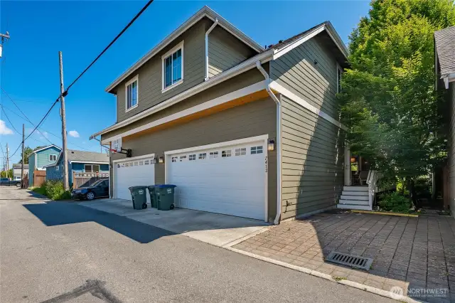 Alley perspective with garage, additional parking, and ADU access from side stairs