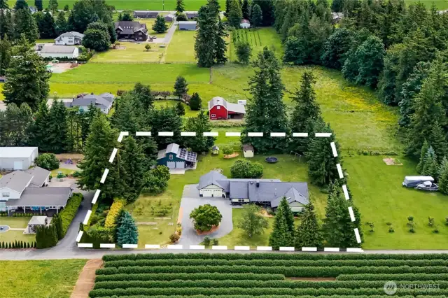 A 1 acre oasis/mini hobby farm with space to spread out.