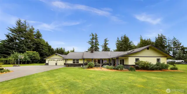 Private setting with a big circular paved driveway and ample parking space. Freshly done landscaping, and a wrap around covered front porch.