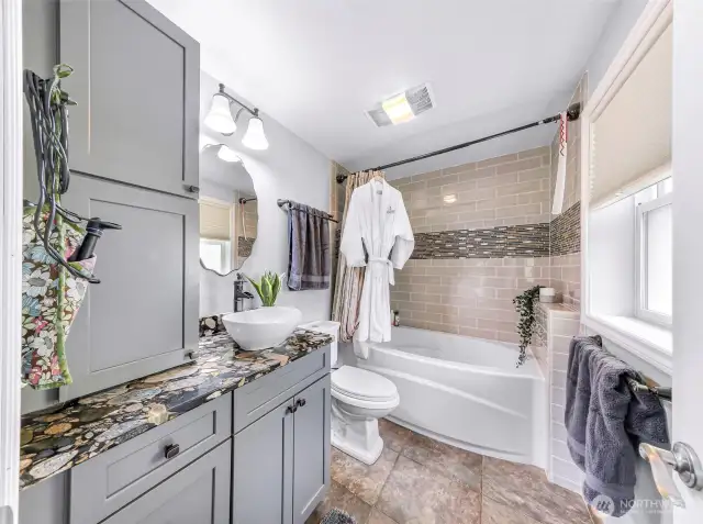 Remodeled bathroom, tile floors, tiled bath and shower, granite counters.