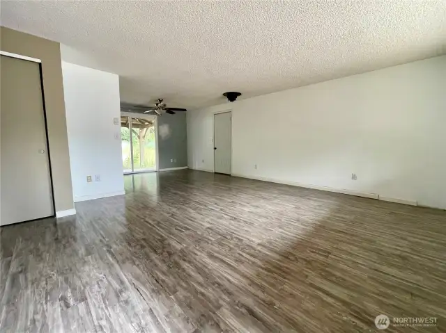 Living Room from Front Door with view of Slider to backyard and Garage Door.