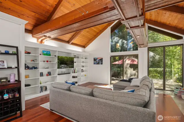 Surround yourself in this family room with operational glass doors hugging you with views of lush trees providing complete privacy and especially enchanting Feng Shui.