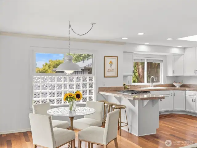 Enjoy casual meals in this charming breakfast nook, steps from a peaceful deck ideal for relaxing outdoors.