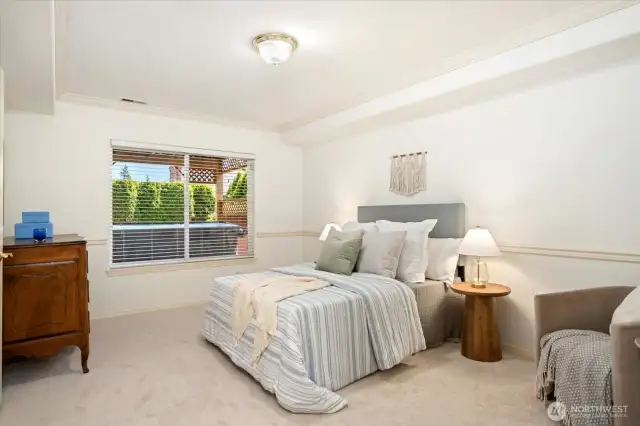 A well appointed guest suite features its own en suite bathroom and a generous walk-in closet.