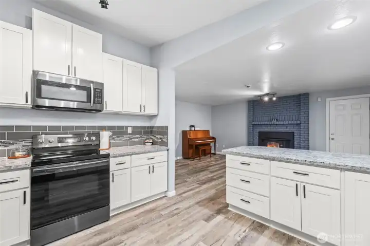 Newer gourmet kitchen with family room and eating bar.