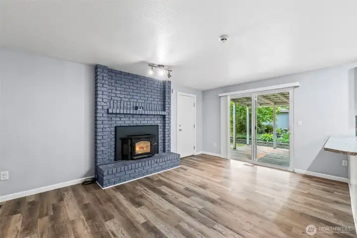 Family room with fireplace off kitchen leading to the lovely covered patio and water feature