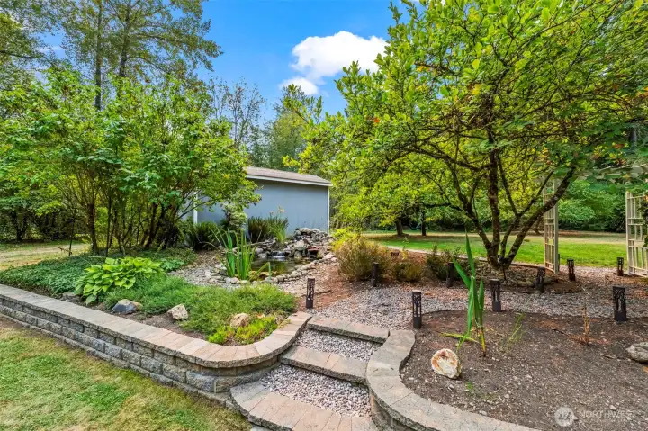 Beautifully landscaped back yard with waterfeature