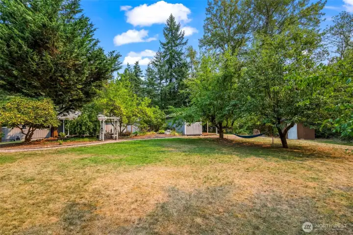 Another back yard view from greenbelt edge of the fully maintained rear yard but property extends from greenbelt area another half +/- acre.  Tranquility abounds!