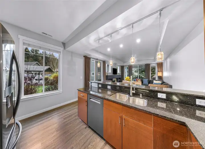 Kitchen overlooks the living space and backyard greenery, creating the perfect layout for everyday living and entertaining.