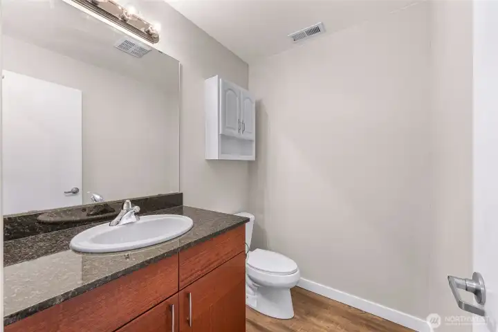 Convenient main level powder room with ample storage and a clean, modern feel.