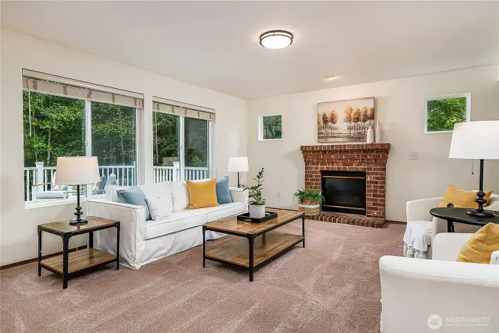 Spacious family room with a cozy brick fireplace and views of the private backyard. With greenbelt on two sides, this room offers both comfort and seclusion.