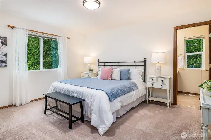 Primary bedroom with en-suite bath. Enjoy plenty of privacy and peaceful views of nature instead of neighbors.