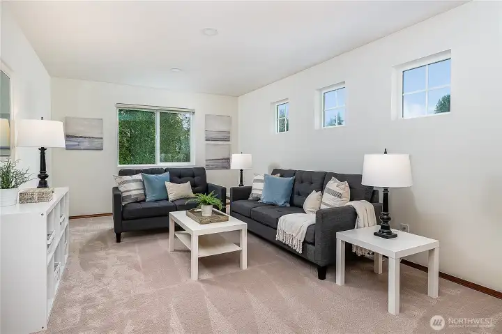 Large bonus room upstairs offers flexible space to watch TV, relax, or work.