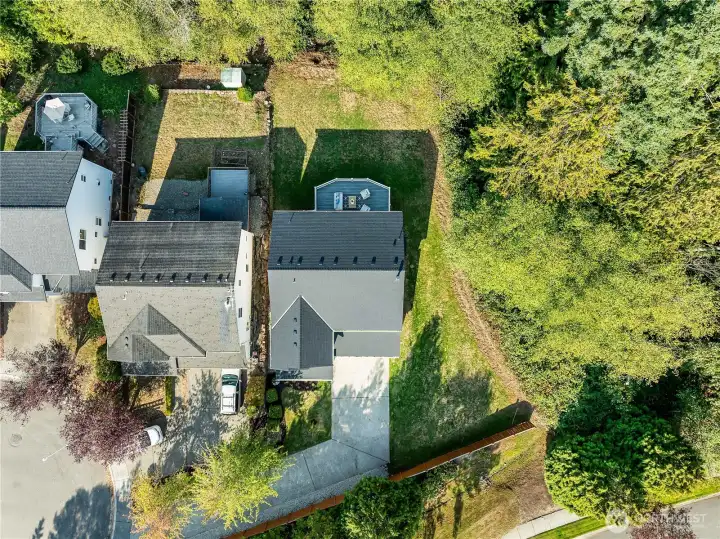 Aerial view of property overhead. Tranquil greenbelt surrounds the property.