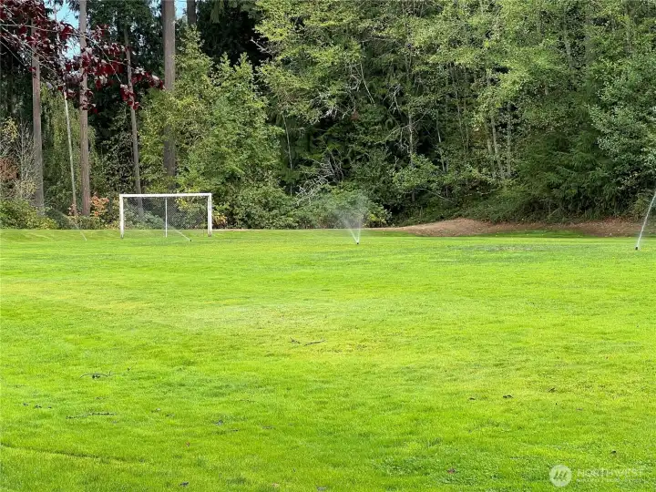 Soccer field nearby, with trails behind it that wind throughout the Silver Firs community.
