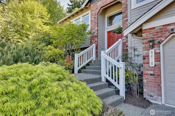 Mature landscaping lines the home's entry. New exterior paint on the home!