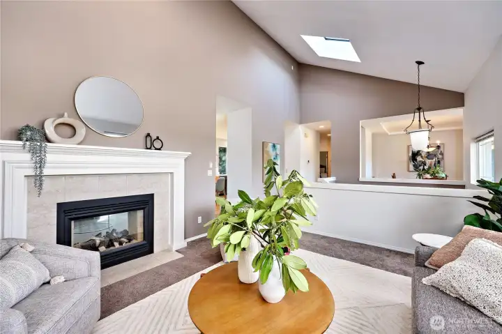 The living room shares the fireplace with the family room, just opposite the wall on the left!