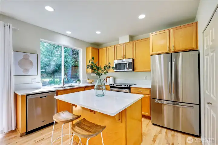 Gorgeous NEW quartz countertops adorn the kitchen and the office alcove. Updated appliances and kitchen sink.