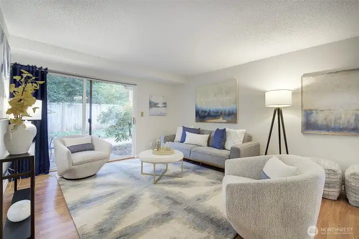 The living room is spacious and light-filled, with the newer vinyl-plank flooring throughout.  There's an additional closet to the left, plus numerous ways to position your furniture.