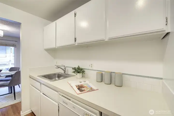 Here's another view of the kitchen showing the bountiful cabinetry/storage and the sink located conveniently by the dishwasher.