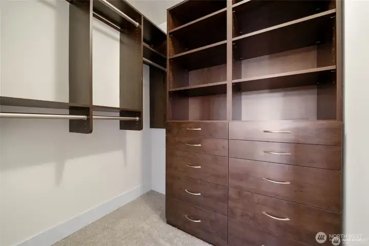 Primary bedroom closet with closet organizers