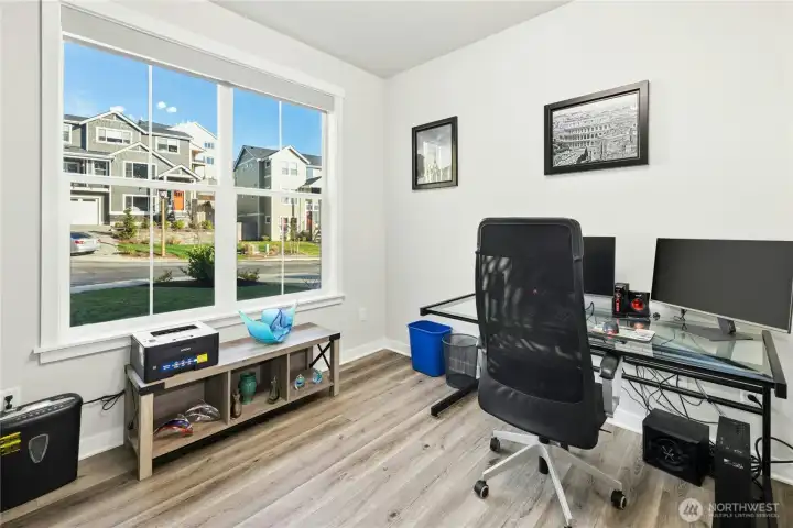 A bright office just off the front door offers a convenient and flexible workspace filled with natural light. Ideal for working from home or meeting clients, this room provides both privacy and functionality.