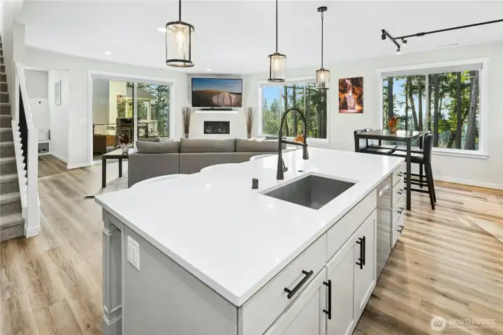 Updated flooring and modern appliances elevate the open-concept kitchen, creating a clean, contemporary look that flows seamlessly into the living and dining areas. Sleek finishes and thoughtful upgrades make this space as functional as it is beautiful.