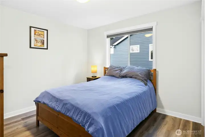 This comfortable bedroom offers a bright, welcoming space with natural light and updated finishes. Perfect for guests or everyday living, it provides a cozy retreat with a clean, modern feel.