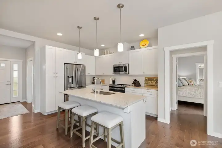 Enjoy this light-filled and roomy chef's kitchen, with tons of cabinetry, high-end stainless appliances, and natural light.