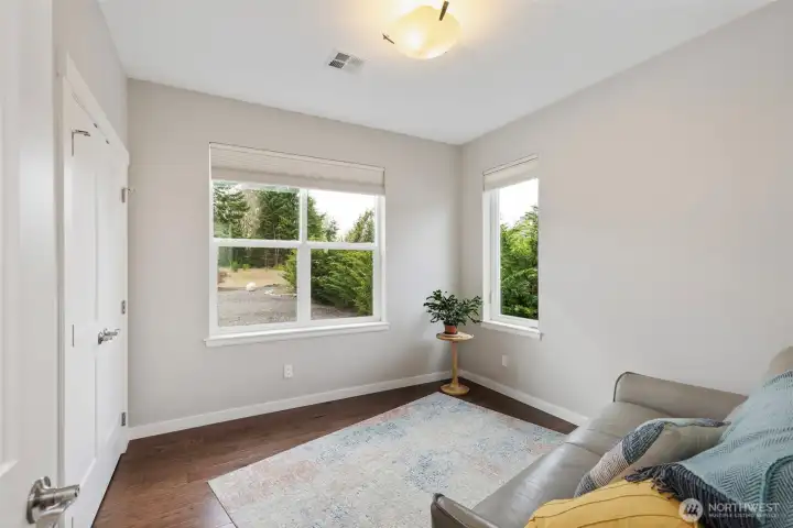 The second bedroom features a roomy closet with built-ins, and huge windows looking into the back yard and the view beyond.