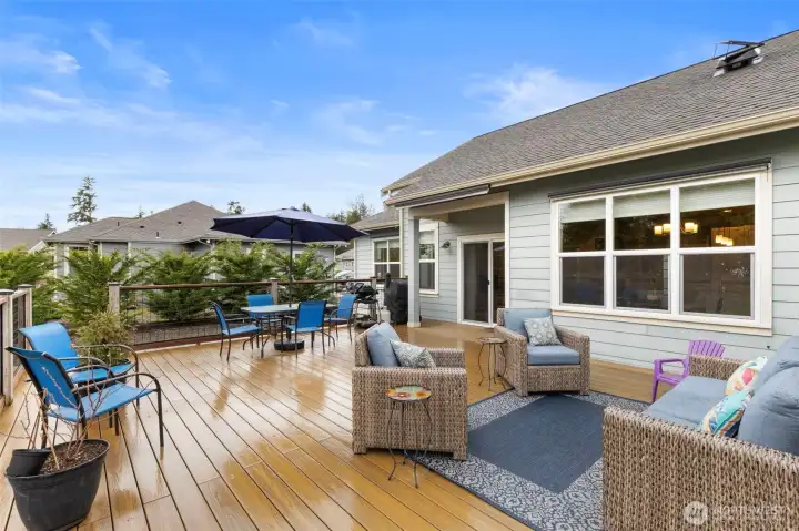 The enormous 637 sf composite deck can handle any gathering you might envision in style! Exterior window shade along the back of the house pull down to protect the inside from sun and excess heat.