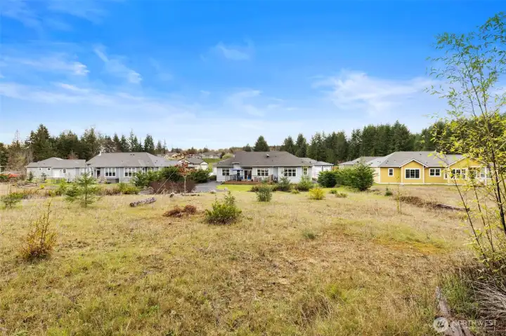 From the back property line of the lot, it's evident the home enjoys the natural beauty Port Ludlow offers.