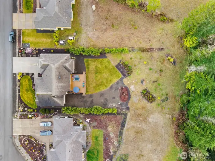Another view from above with careful landscaping along both sides of the back of the property ensuring private, peaceful living. Welcome home to warm, gracious living in the heart of the Olympic Peninsula!