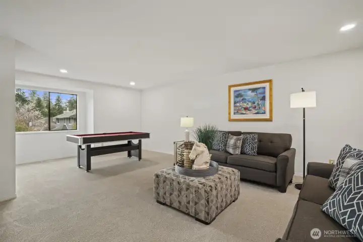 Extra large family room has space for media room and game area.