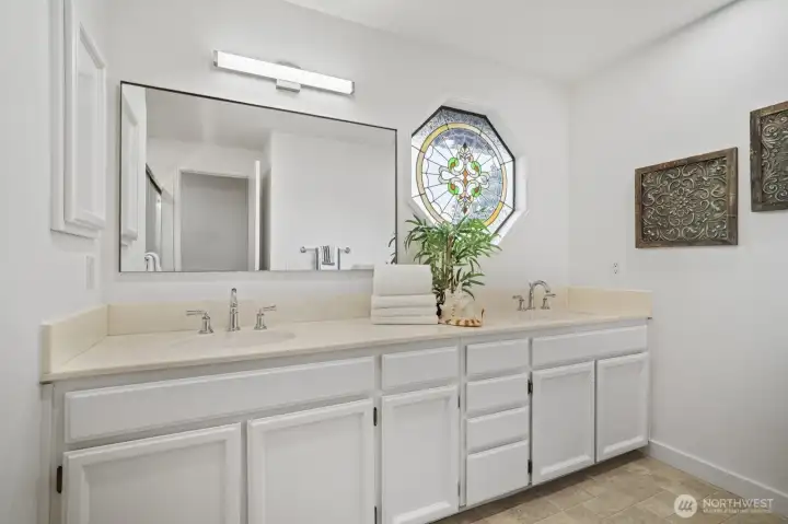 Hall bath upstairs includes dual vanities, tub, and shower.