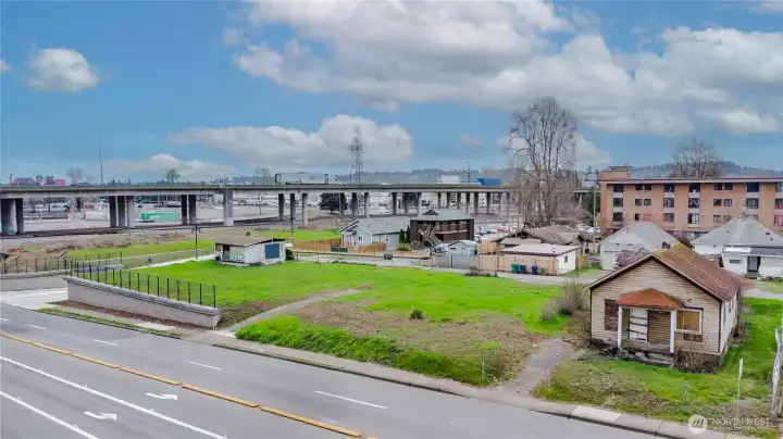 Former home on right no longer of value. Buildings behind as well are boarded up
