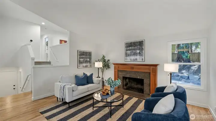 The Great room is highlighted by a wood burning fireplace featuring a gorgeous wood mantle accented by granite surround.