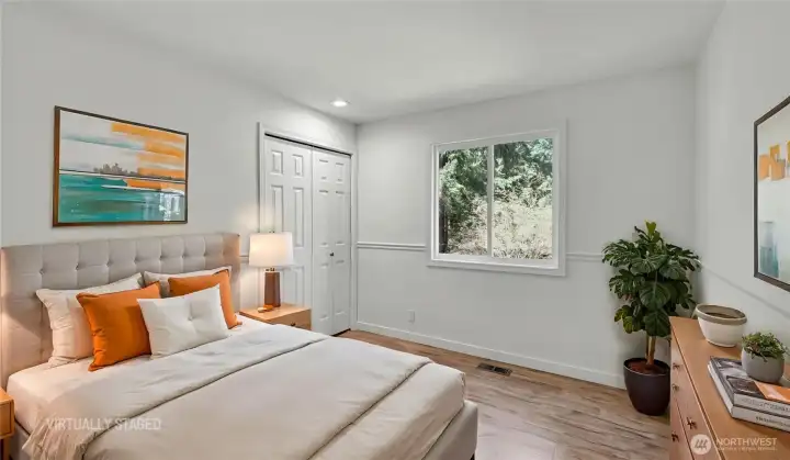 Secondary bedroom with large window and plenty of space. Virtually staged.