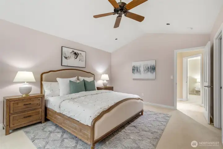 Designer color palette, ceiling fan and vaulted ceilings with a view overlooking the private backyard.