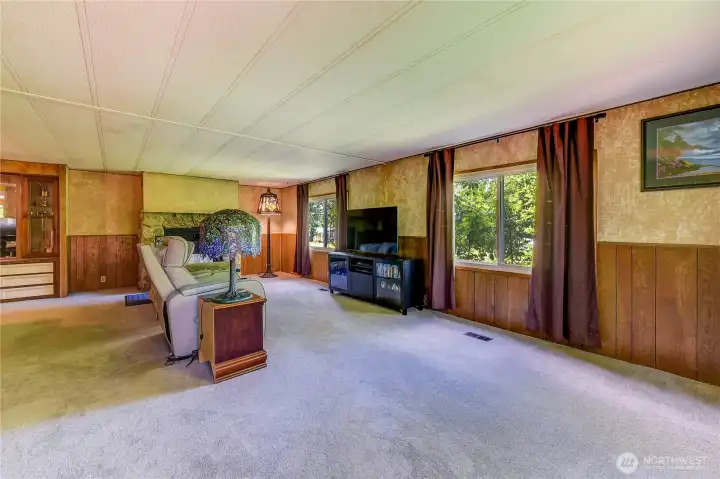 Bright living room with wood burning fireplace insert